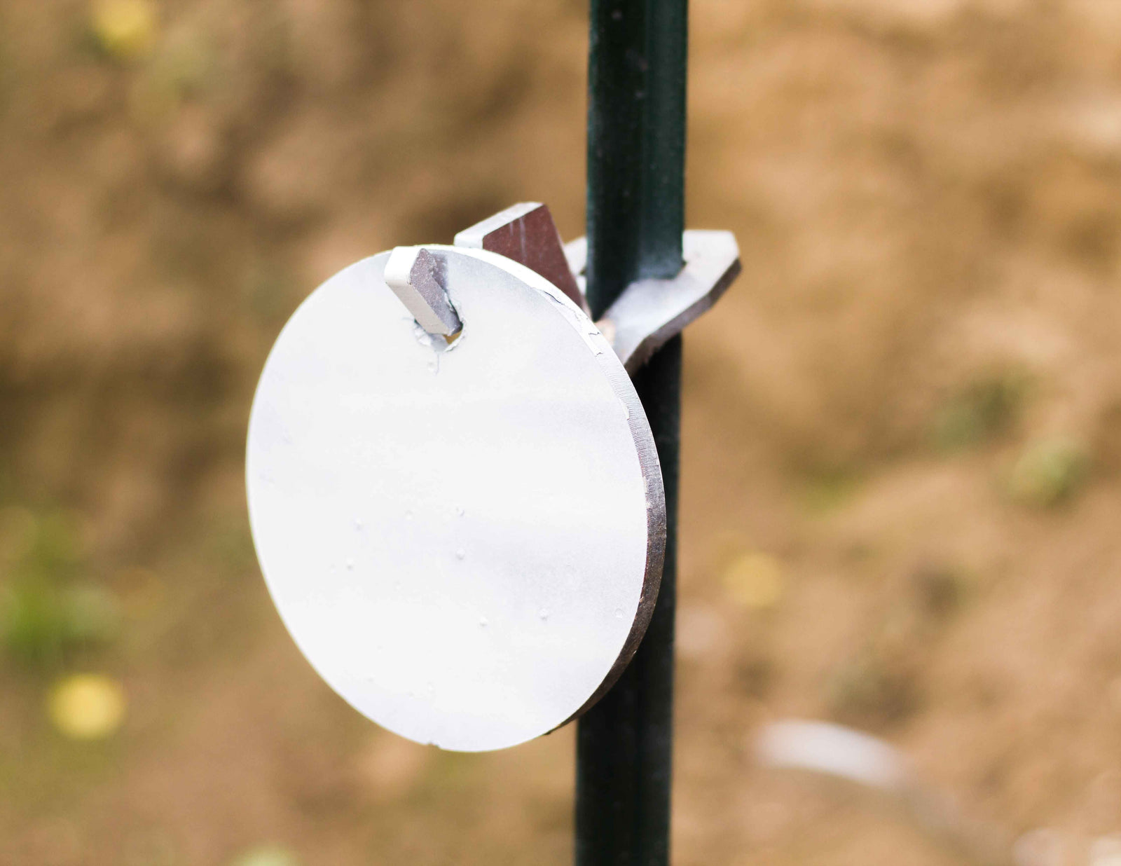 6 inch single hole round gong hanging on a single hook t-post mount