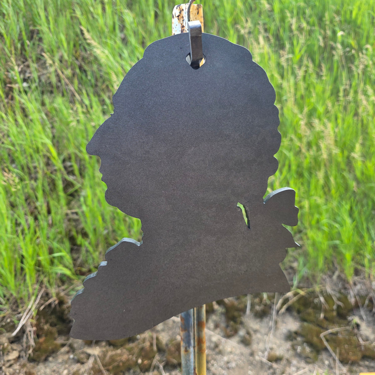 king george III sillhouette SR500-AR500 target hanging on a t-post hook mount in front of berm