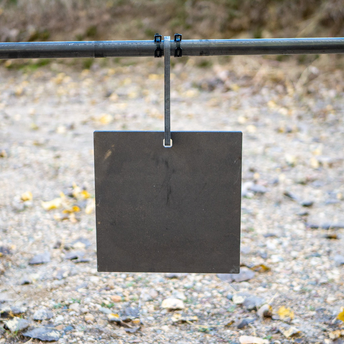 single hole square gong hanging on a pipe hook target hanger close up
