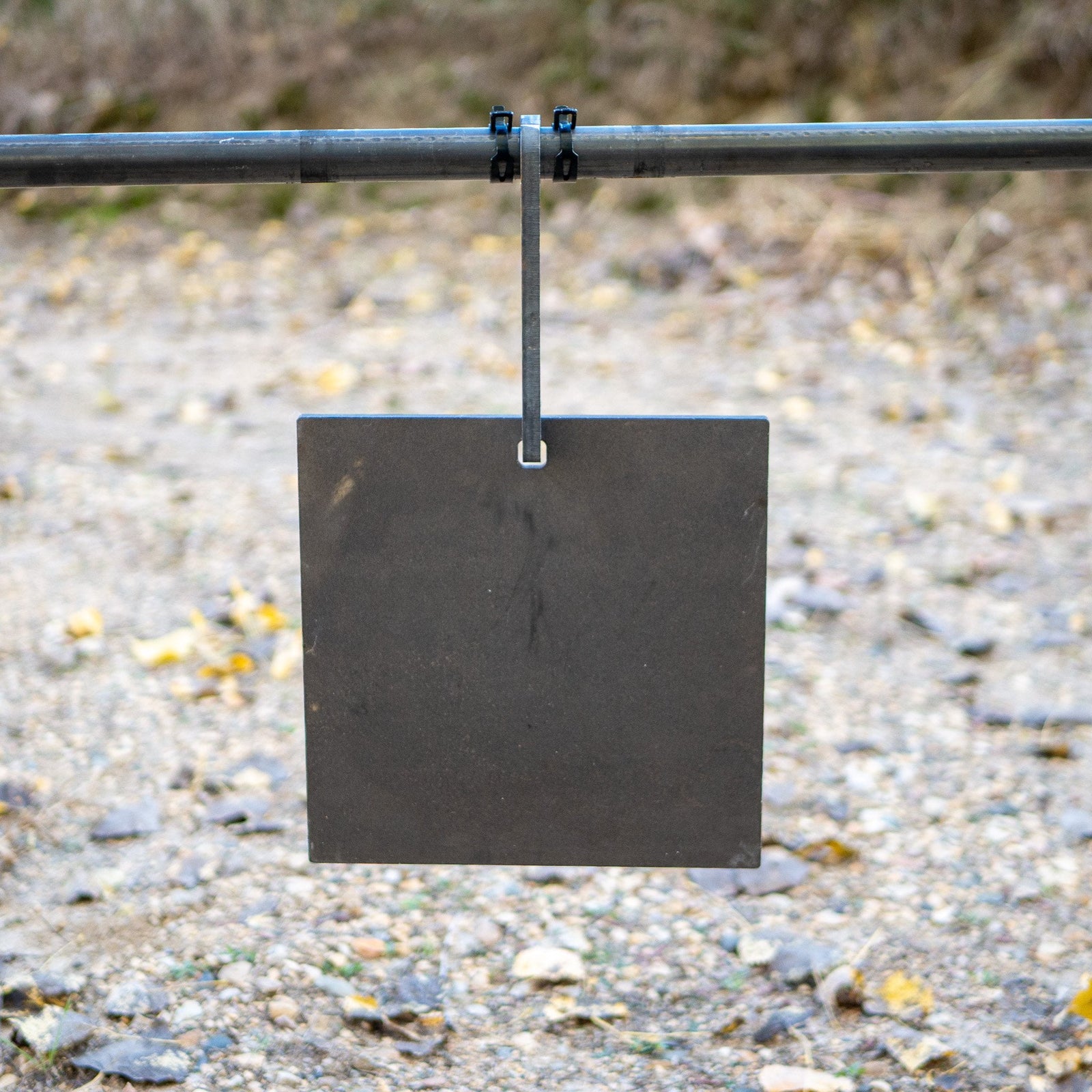 single hole square gong hanging on a pipe hook target hanger close up