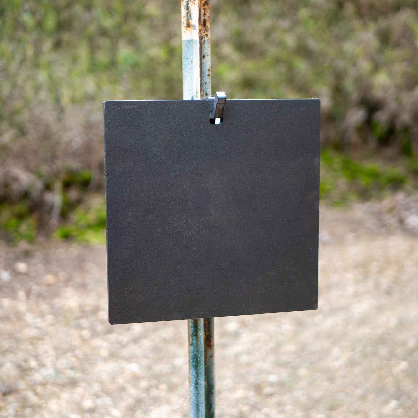 single hole square gong hanging on a single hook t-post mount front view